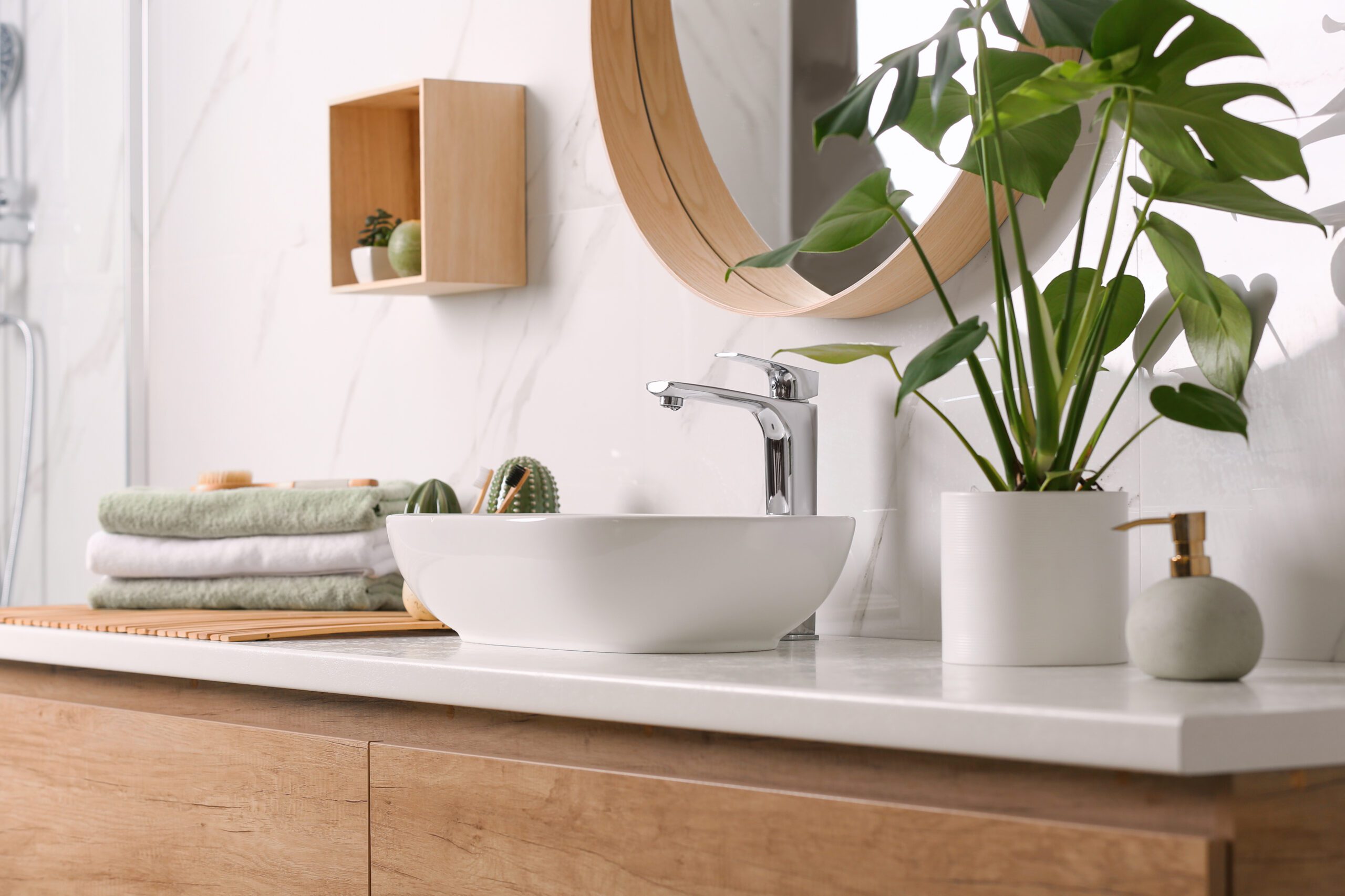 Stylish vessel sink on light countertop in modern bathroom